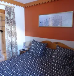 Slaapkamer 1 met wastafel en douche